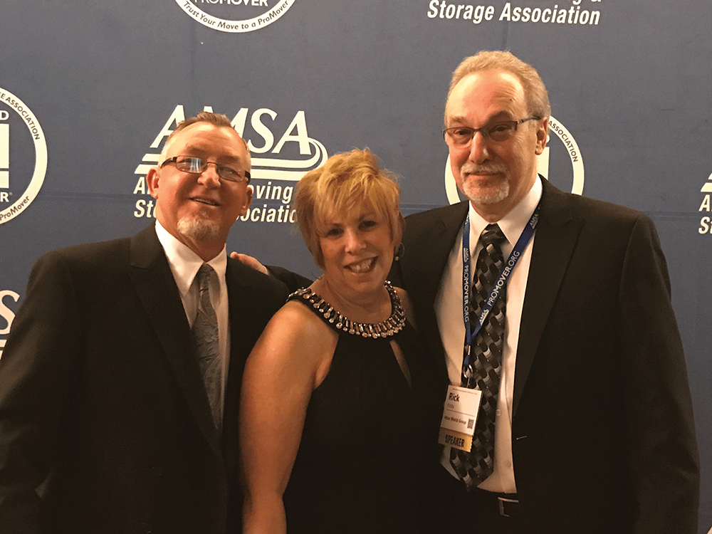 A picture of three people smiling at an AMSA event